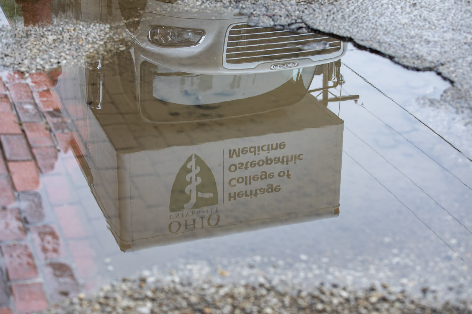 Reflection of mobile clinic in puddle